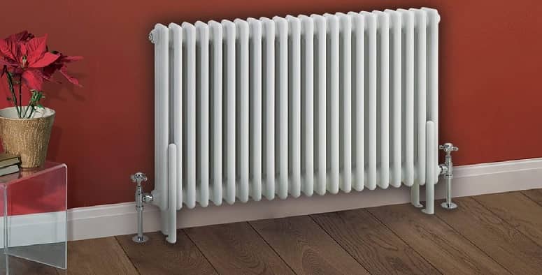 white horizontal radiator in front of red wall