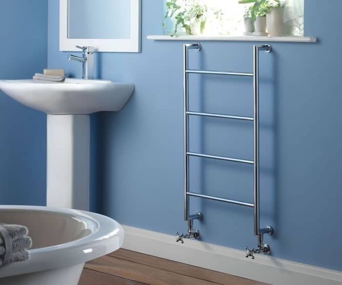 minimalist towel warmer on blue bathroom wall
