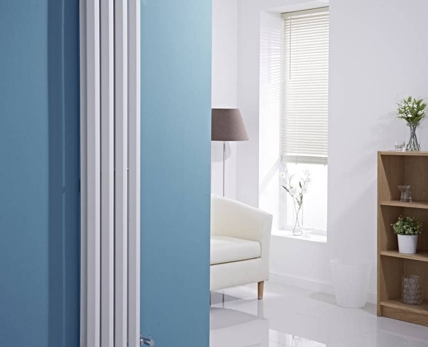vertical white radiator blue wall
